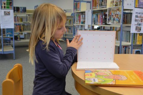 Child reading in school library