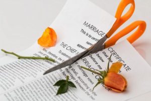 Divorce; marriage certificate cut by scissors