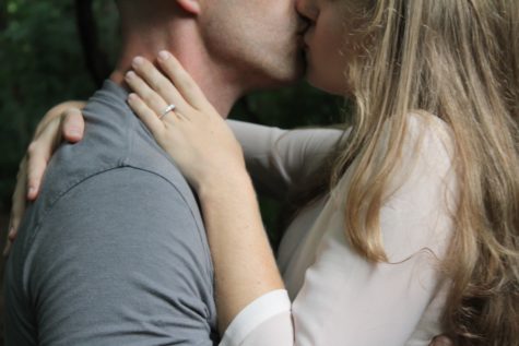 Engaged couple kissing