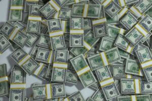 Piles of cash in hundred dollar bills 