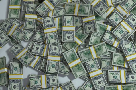 Piles of cash in hundred dollar bills