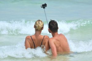 Couple taking a selfie at the beach