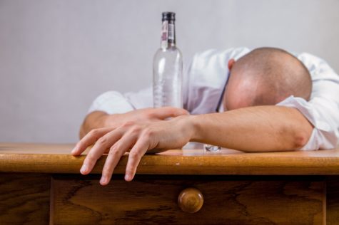 Drunk man passed out with bottle of alcohol
