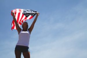Girl holding up American flag