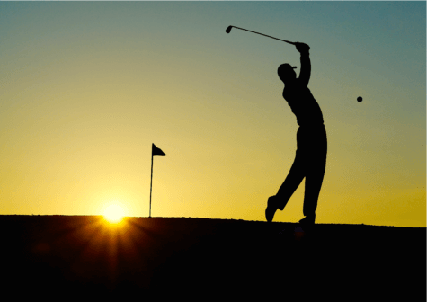 Silhouette of person playing golf