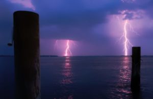 Lightning strikes, storms over ocean