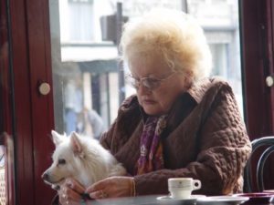 Sad woman with dog in coffee shop