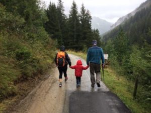 Couple walking with child on hiking trail