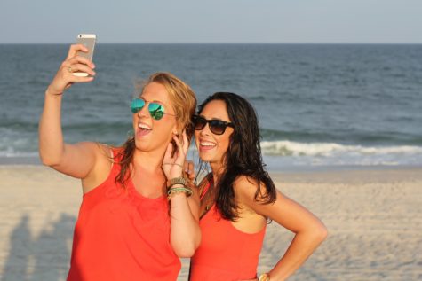 Women snapping a selfie at the beach