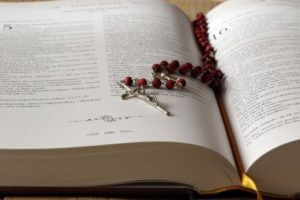 Rosary laying on Bible