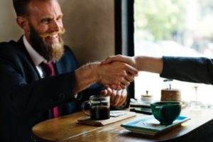 Man meeting with someone, shaking hands