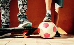 Boys with soccer ball, skateboard
