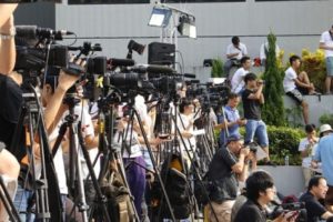 Television news reporters and cameras