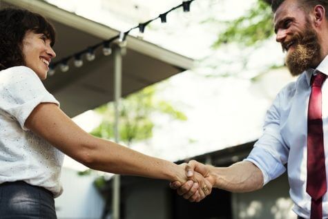 Handshake between man and woman at meeting