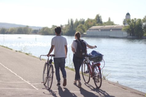 Man and woman walking next to their bicycles