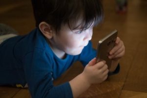 Little boy looking at smartphone