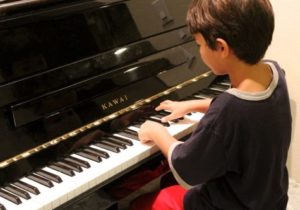 Boy taking piano lesson
