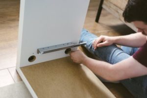 Man putting cabinet together DIY project
