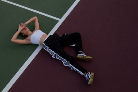 Woman lying on tennis court