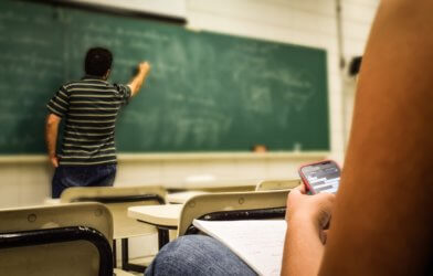 Student on phone in college class