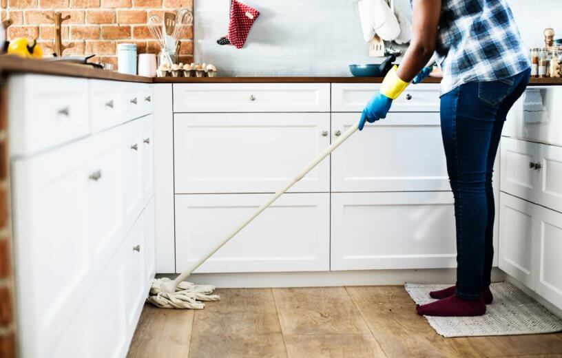 Person mopping a kitchen