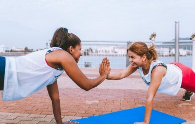 Women exercising and high-fiving