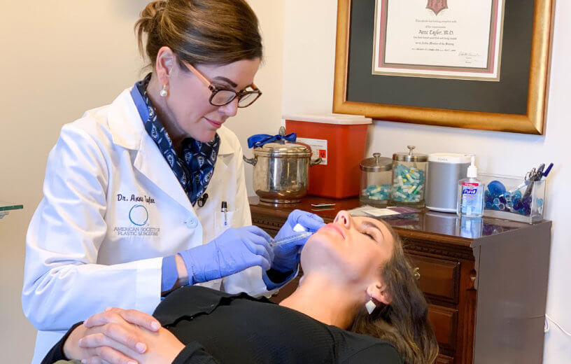 Dr. Anne Taylor administers lip injections to a patient