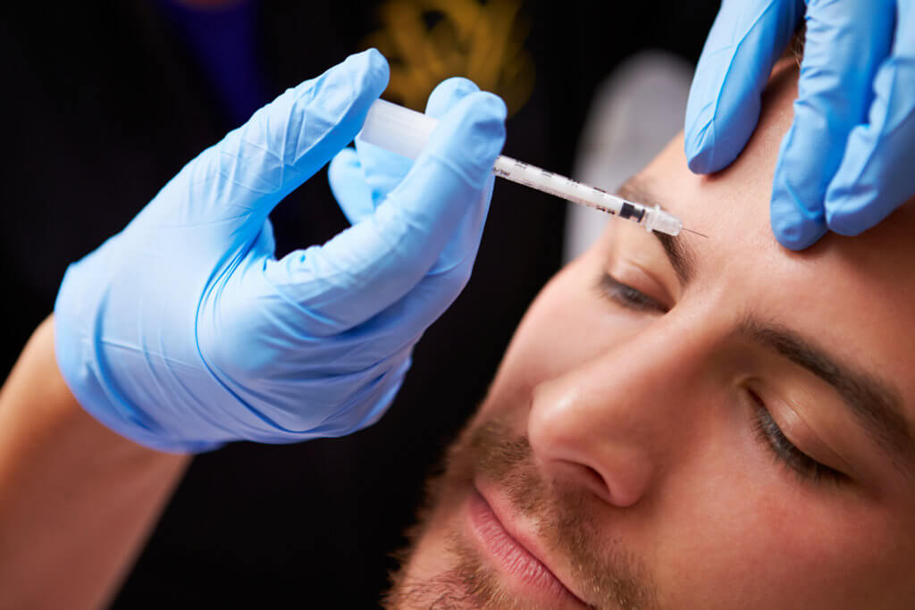 Man having Botox injection, cosmetic procedure