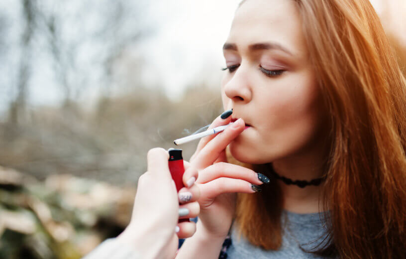 Teen girl smoking cigarette
