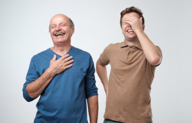 Dad jokes: Father, son laughing after telling a jokeDad jokes: Father, son laughing after telling a joke