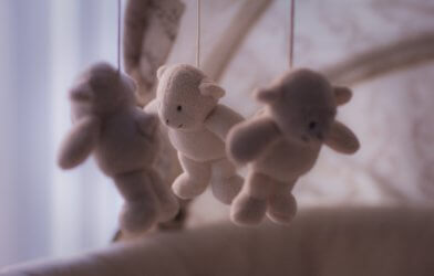 Stuffed bears hanging from baby's crib