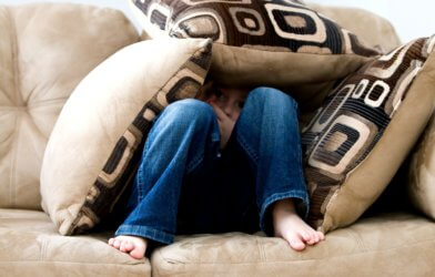 Child hiding on the couch