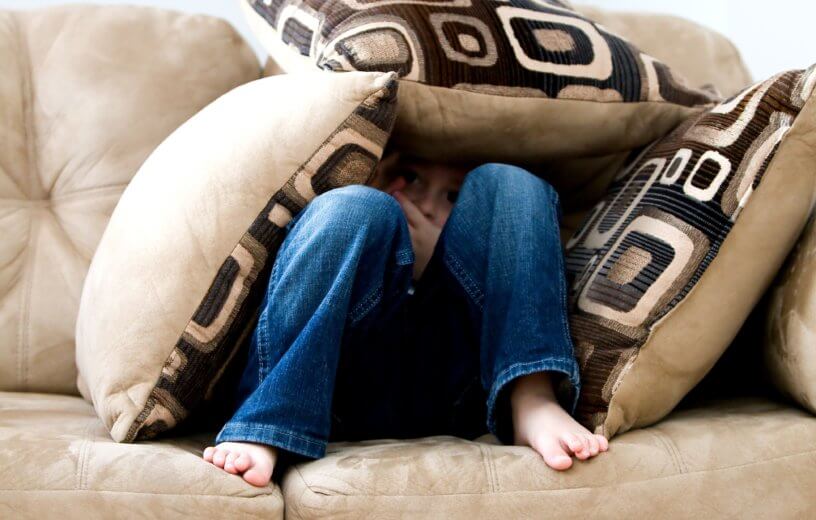 Child hiding on the couch