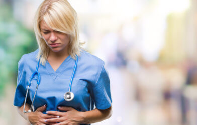 Nurse or doctor feeling upset stomach pain at hospital