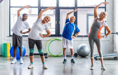 Seniors, older adults enjoying exercise class at gym
