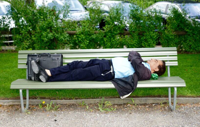 Man sleeping or taking a nap on a bench