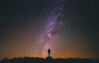 Person looking up at outer space, night sky