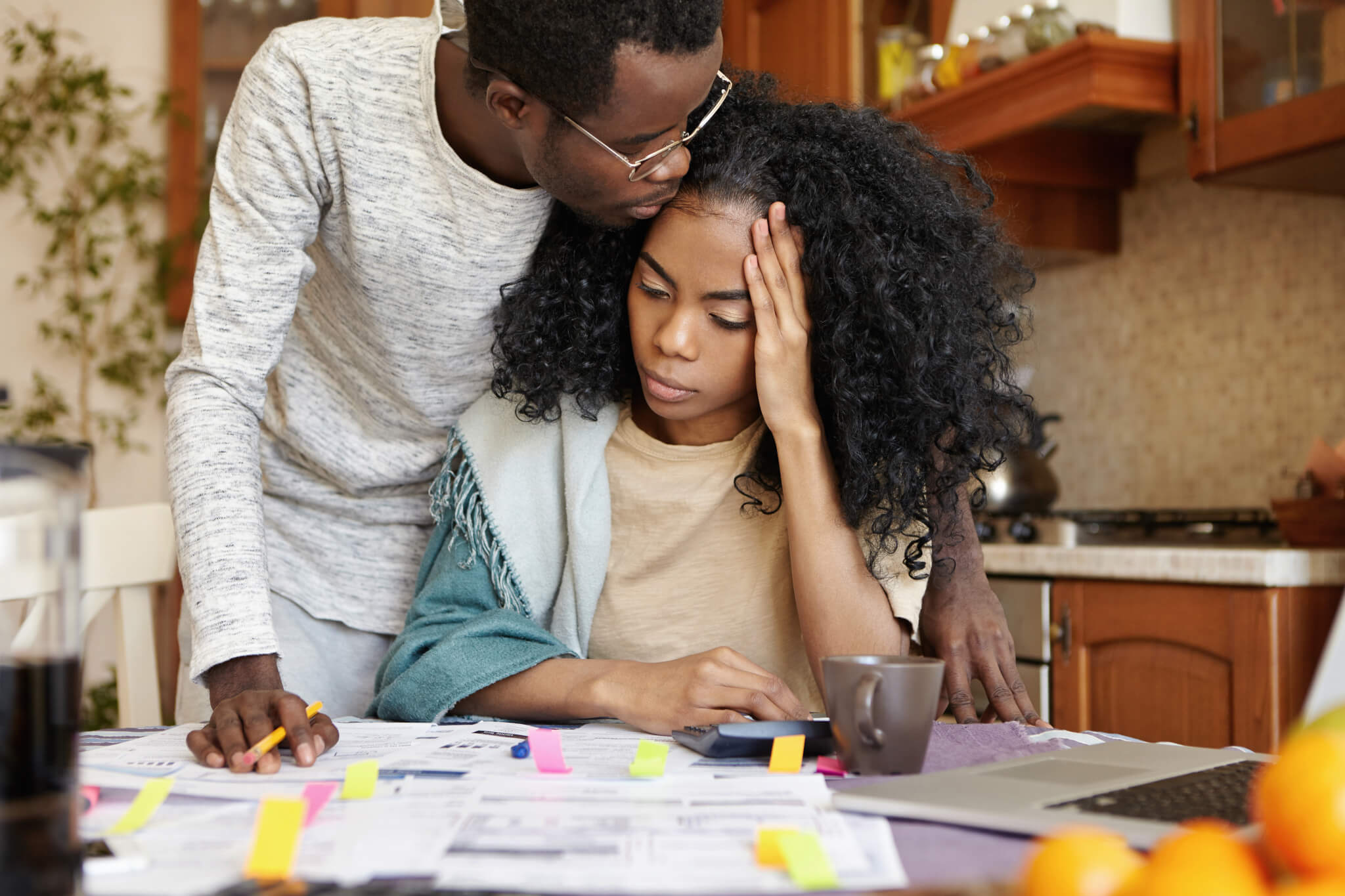 Couple experiencing financial stress while reviewing bills
