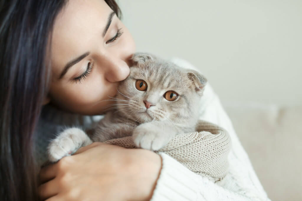 Woman kissing her cat
