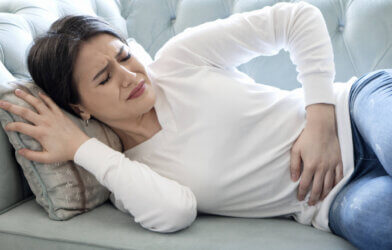 Woman experiencing stomach or menstrual pain