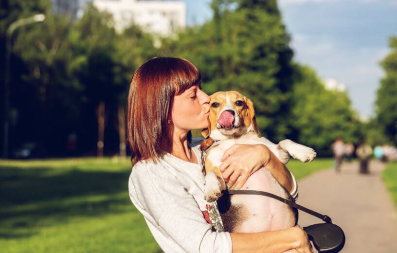 Woman giving her dog a kiss