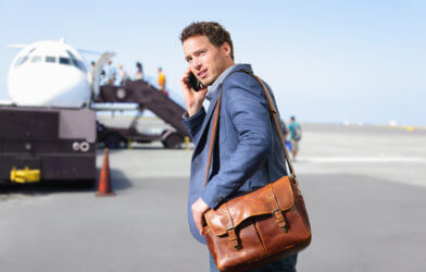 Man talking on phone before boarding airplane