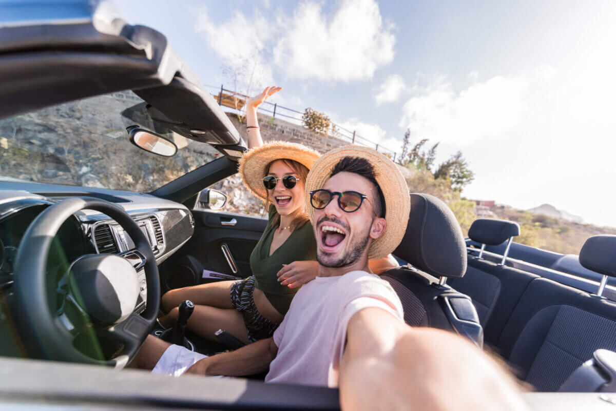 Young couple snapping selfie while driving