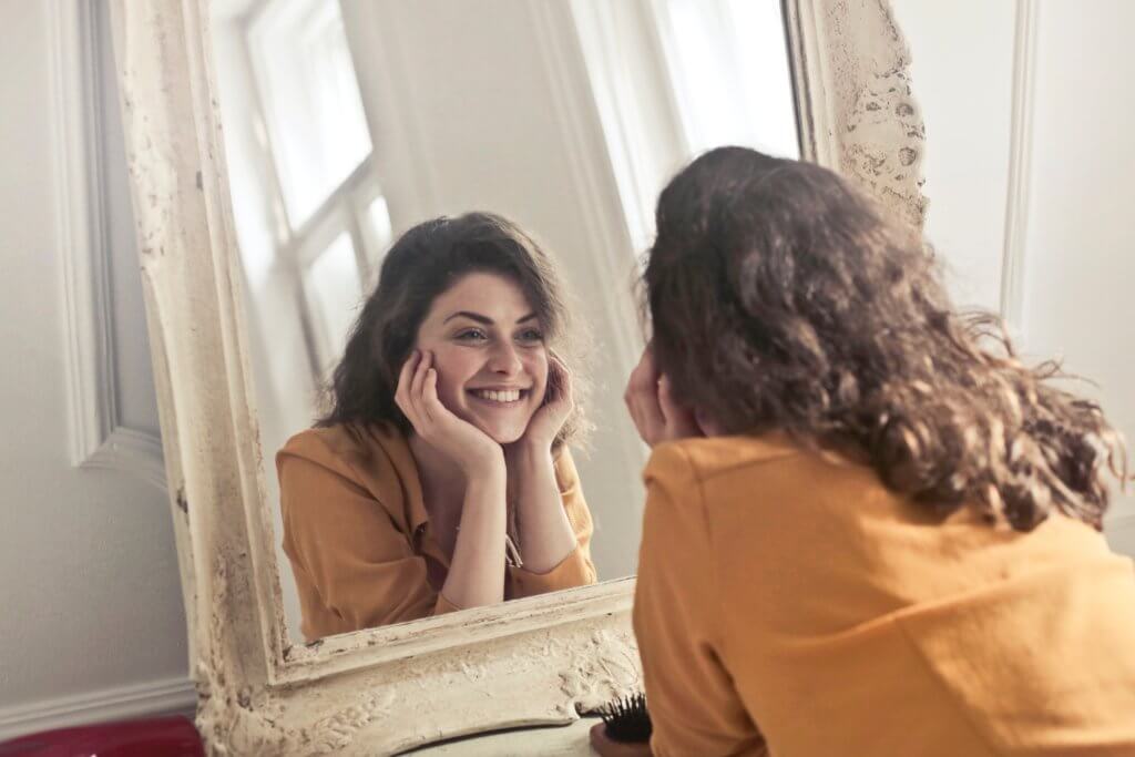 Woman staring at herself in the mirror