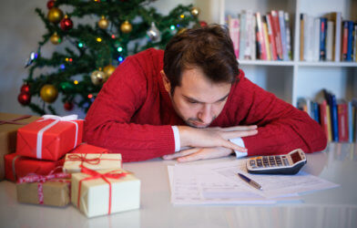 Man in debt from holiday spending, expenses