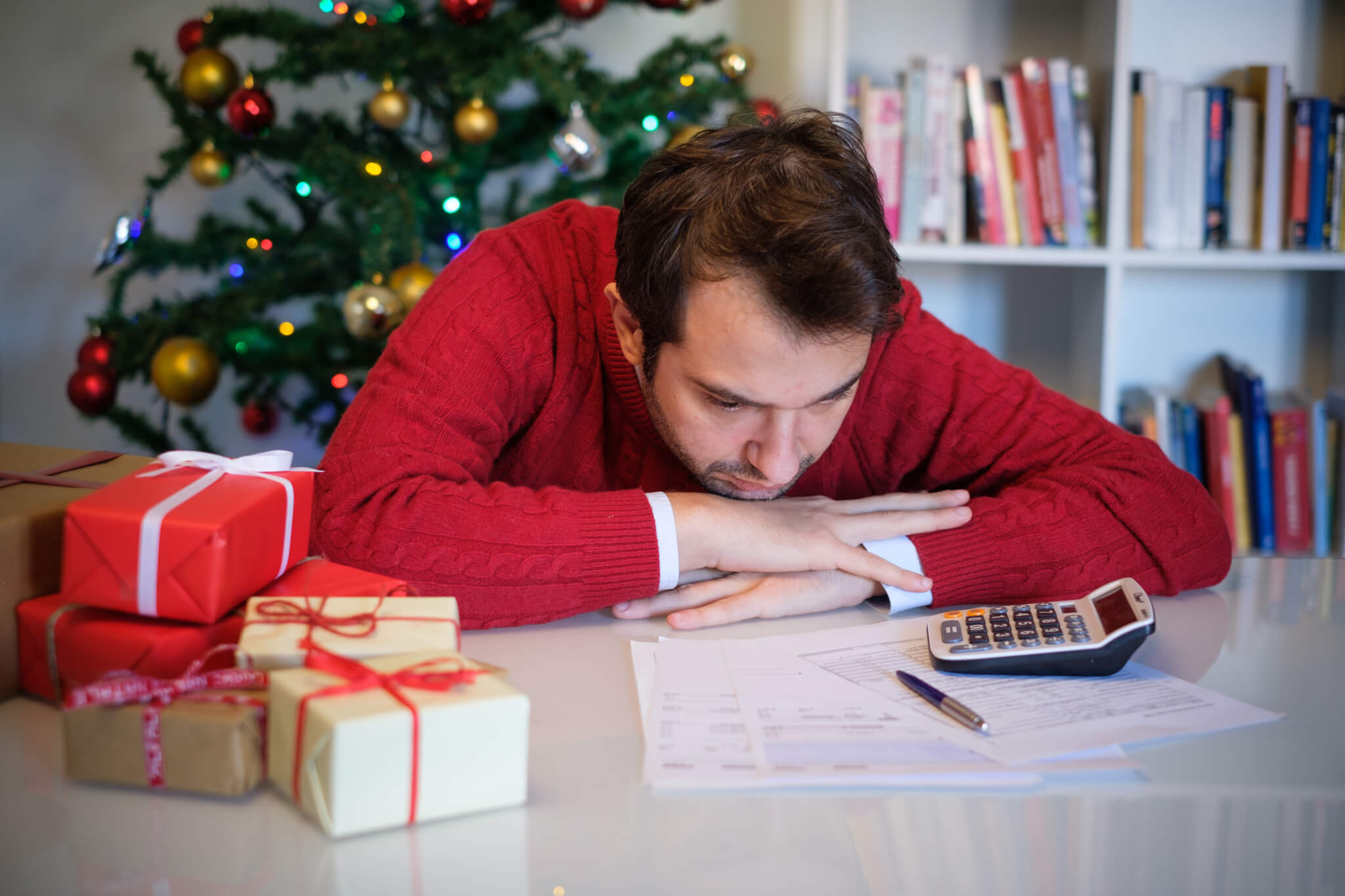 Man in debt from holiday spending, expenses