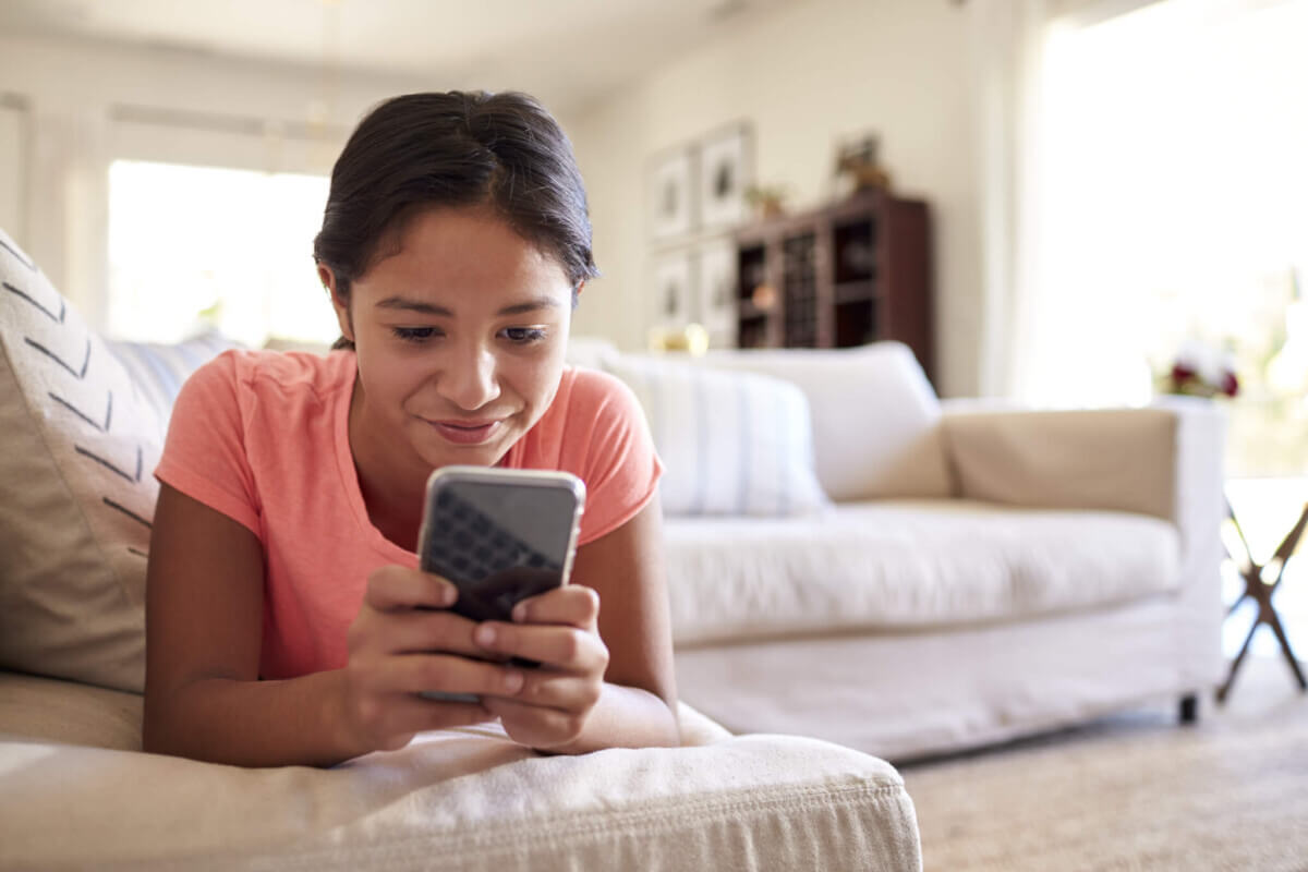 Screen time: teenage girl looking at social media on smartphone