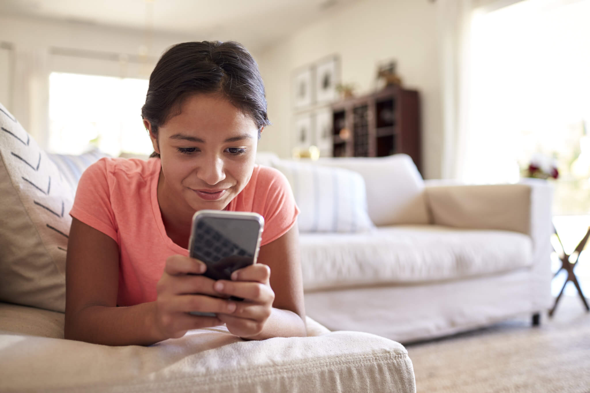Screen time: Teen girl looking at social media on smartphone
