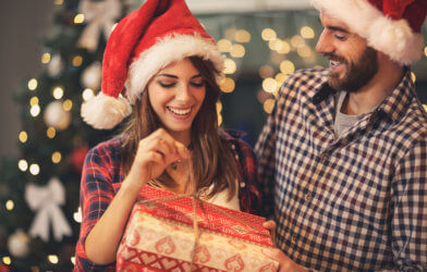 Man and woman opening Christmas gifts