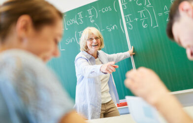 Teacher or professor laughing with students